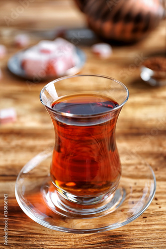 Fototapeta Naklejka Na Ścianę i Meble -  Turkish tea in traditional glass on wooden table closeup