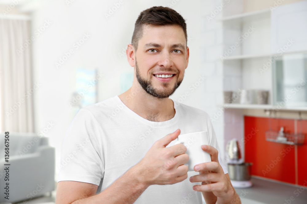 Handsome young man drinking coffee at home Handsome young man drinking coffee at home