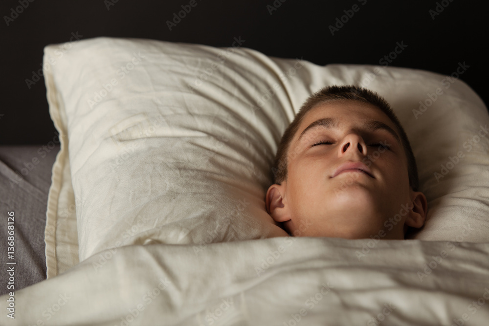 Boy asleep in bed with head on pillow Boy asleep in bed with head on pillow