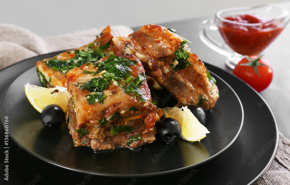 Plate with meat on table