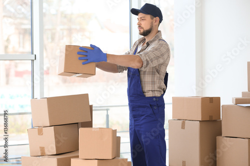 Delivery man moving boxes i...