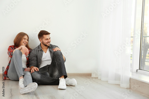 Happy young couple sitting ...