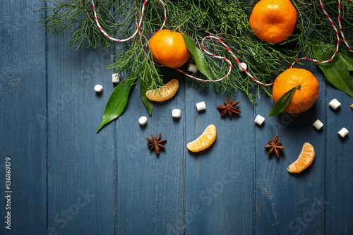 Fototapeta Naklejka Na Ścianę i Meble -  Composition of tangerine, spices and coniferous branches on wooden background