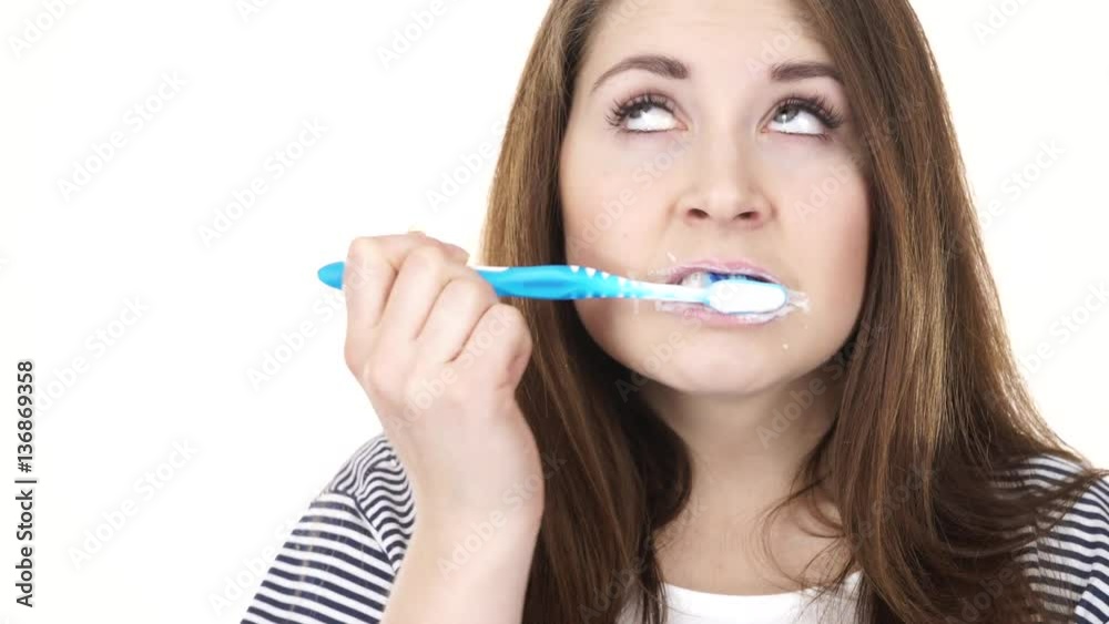 Woman dark long hair brushing cleaning teeth. Positive girl with toothbrush. Oral hygiene. Studio shot isolated on white background 4K ProRes HQ codec Woman dark long hair brushing cleaning teeth. Positive girl with toothbrush. Oral hygiene. Studio shot isolated on white background 4K ProRes HQ codec