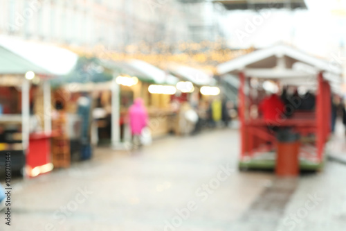 Blurred background of stalls at traditional Christmas fair © Africa Studio