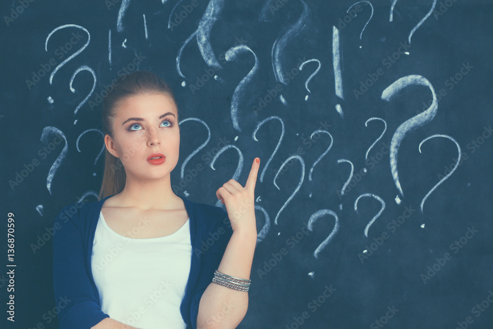 Young girl with question mark on a gray background