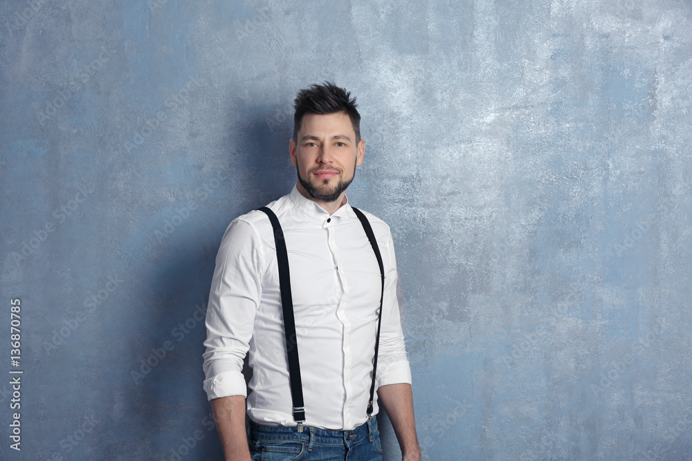 Handsome young man posing on gray background