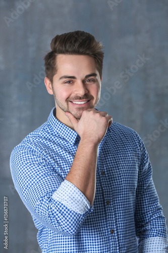 Handsome young man on color background