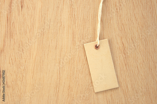Light cardboard price label tag on wooden background