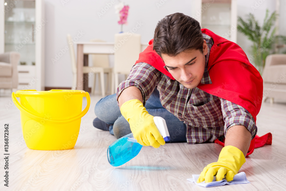 Super hero husband cleaning floor at home Super hero husband cleaning floor at home