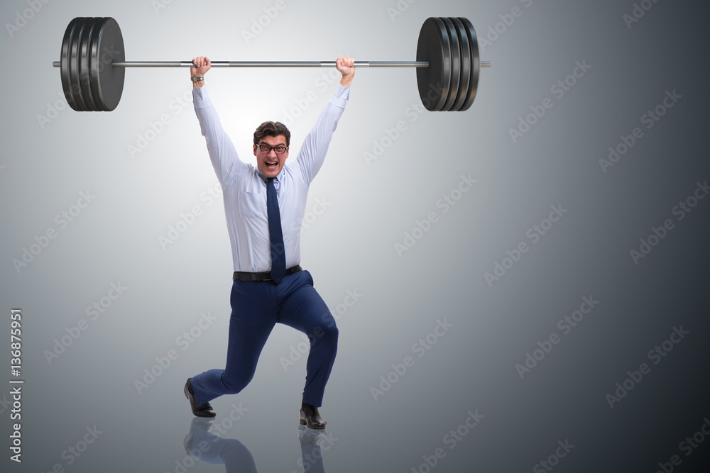 Businessman with barbell in heavy lifting concept Businessman with barbell in heavy lifting concept