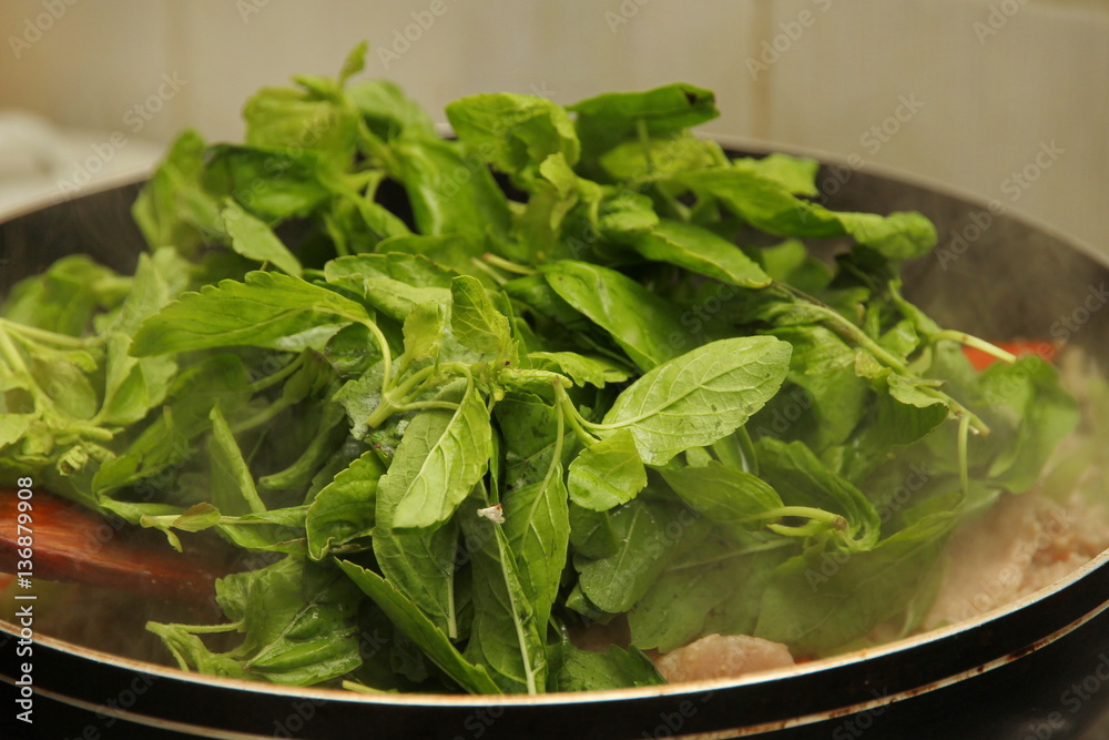 Cooking of fried spicy basil with minced pork topped lettuce. Cooking of fried spicy basil with minced pork topped lettuce.