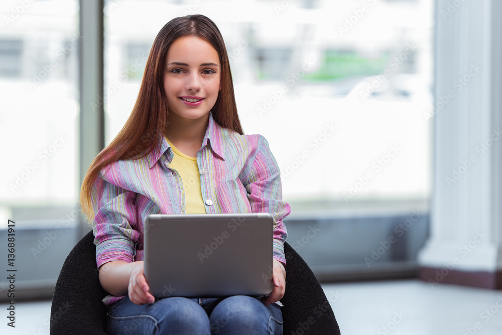 Fototapeta premium Young girl surfing internet on laptop