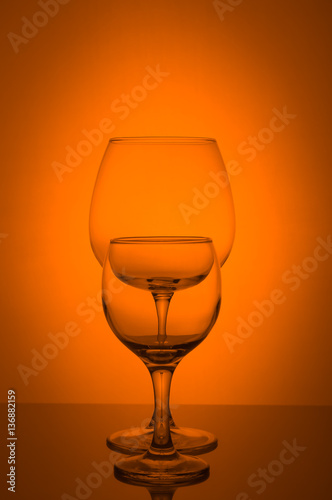 Two wine glass on orange background