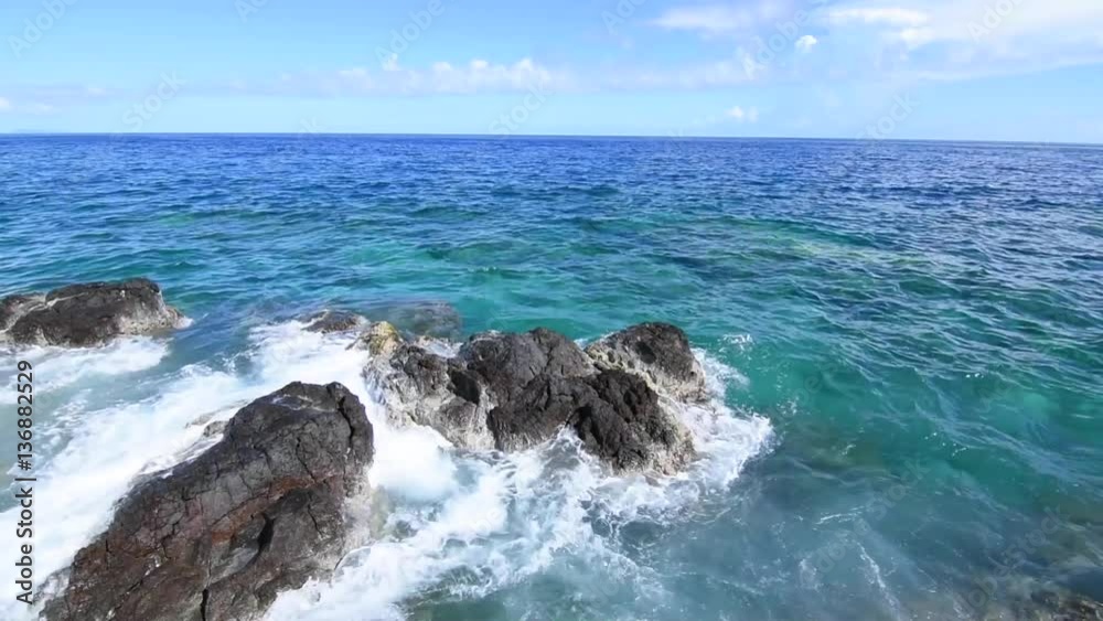 Waves washing over rocky reef shoreline with deep clear water at Punta Soldado in Isla Culebra, with native sound Waves washing over rocky reef shoreline with deep clear water at Punta Soldado in Isla Culebra, with native sound
