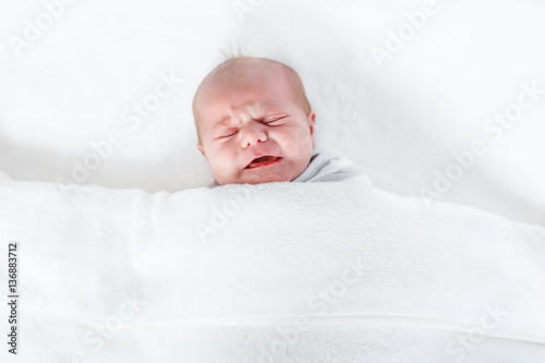 Portrait of cute adorable newborn baby child crying