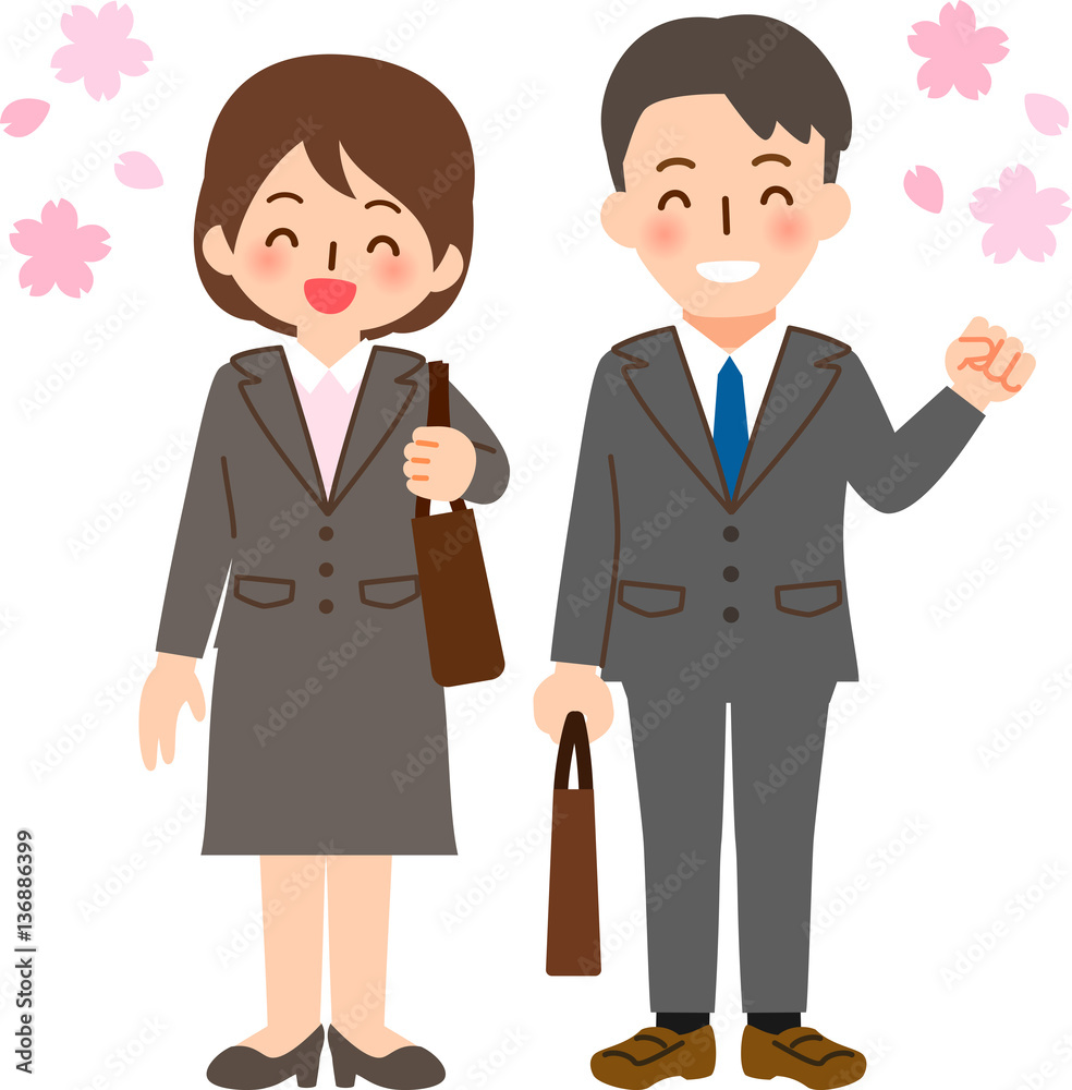 スーツを着た笑顔の男女と桜