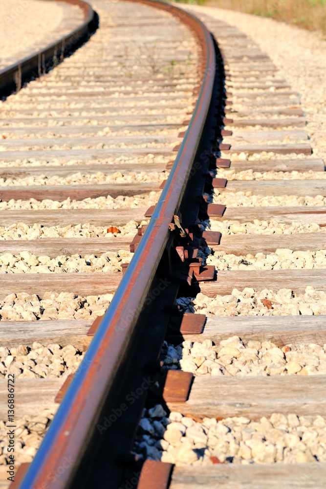 Fototapeta premium Traditional tie plates and spikes seure modern welded rail to traditional wooden ties. Time honored method of constructing railroads for well over a century in the United States.