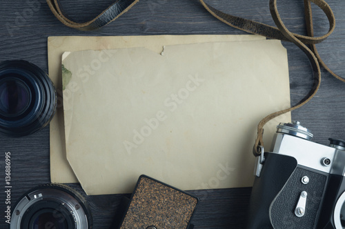 Old camera and lenses on dark wooden background photo