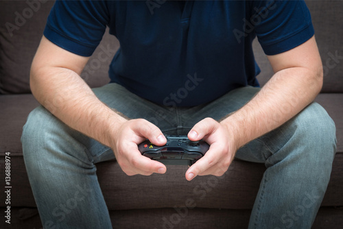 video game console controller in man hands