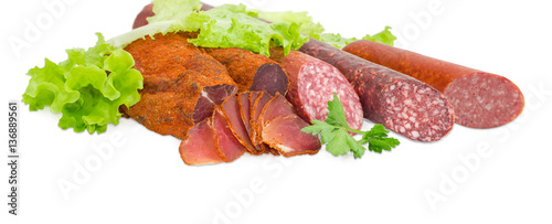 Dried pork tenderloin and different varieties of sausages closeup