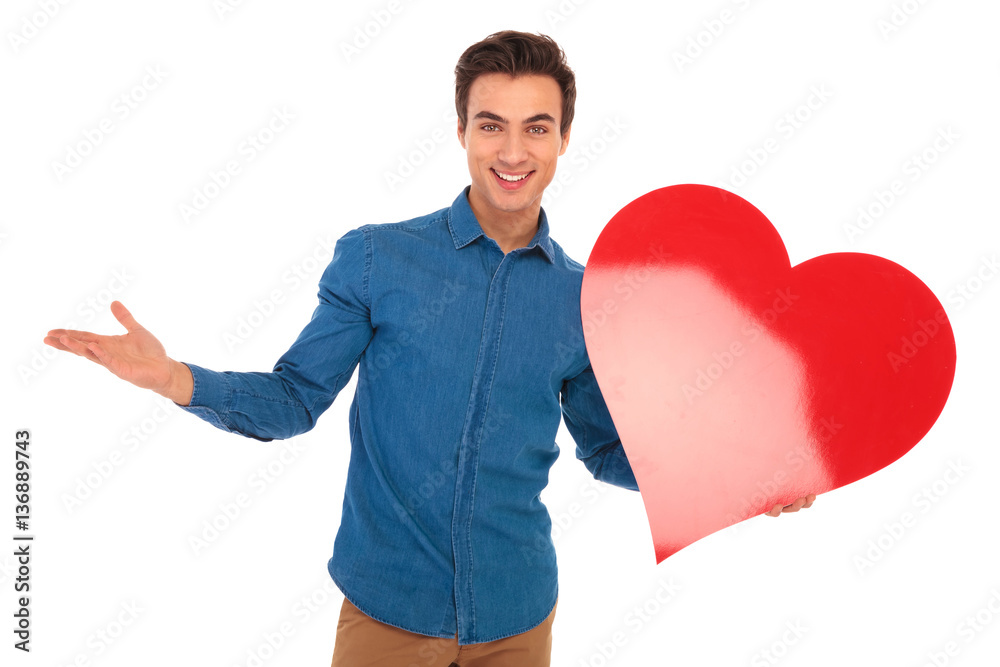happy young casual man welcoming you to valentine's day happy young casual man welcoming you to valentine's day