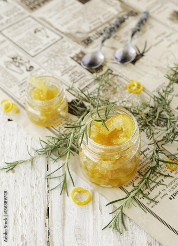 orange marmalade in small glass jars with rosemary, selective focus