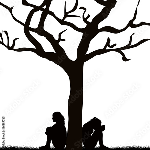 Sad women sitting under a tree