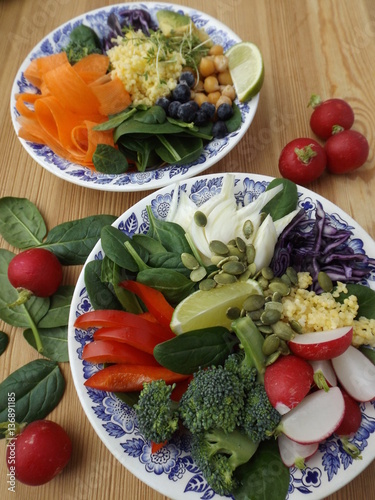Buddha Bowl. The concept of healthy vegetarian food. Fresh raw vegetables, boiled millet and chickpeas. Two different variants photo