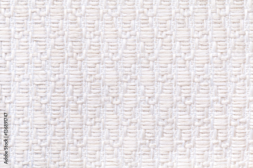 White knitted woolen background with a pattern of soft, fleecy cloth. Texture of textile closeup.