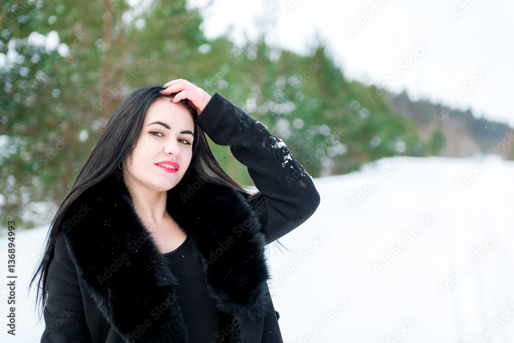 portrait of a beautiful young girl on a background of a winter p portrait of a beautiful young girl on a background of a winter p