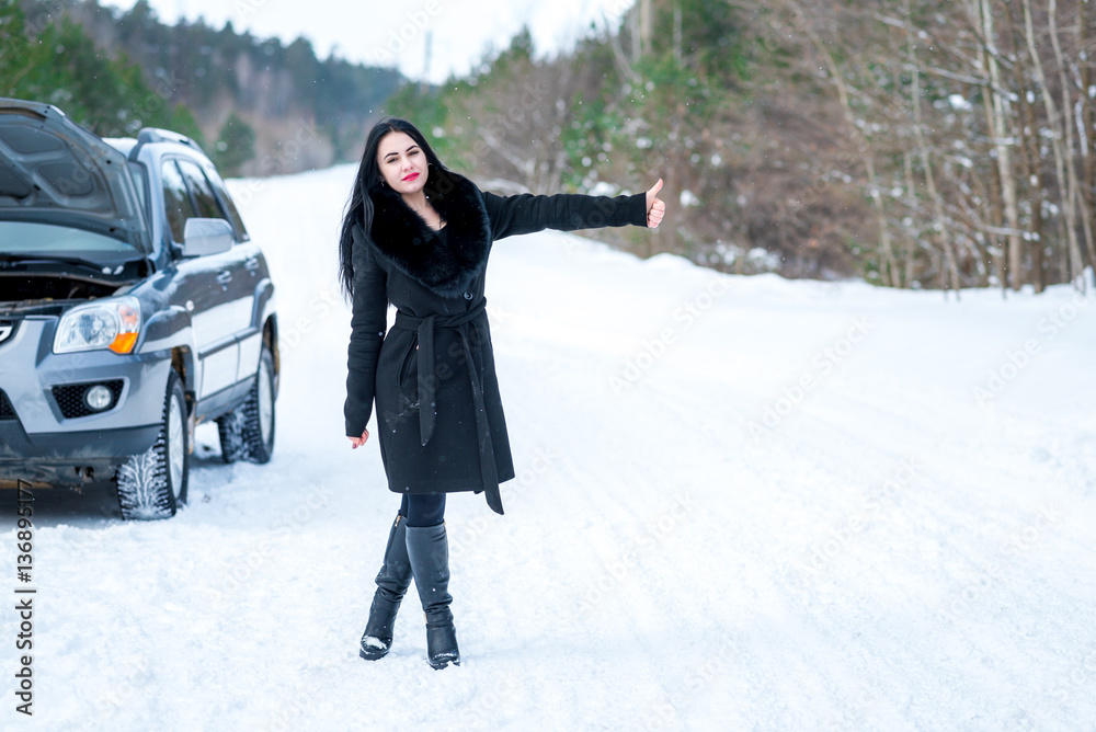 young beautiful woman signaling problems with broken car on win young beautiful woman signaling problems with broken car on win