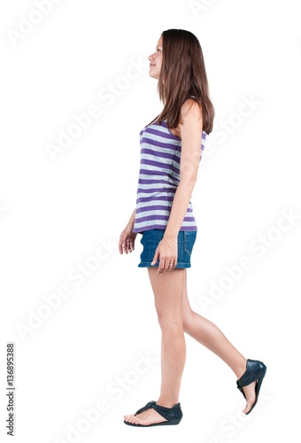 back view of walking woman . going gir in motion. Rear view people collection. backside view of person. Isolated over white background.