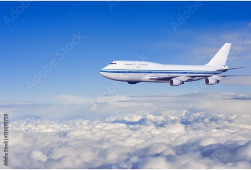 passenger airplane in the clouds. © ghoststone