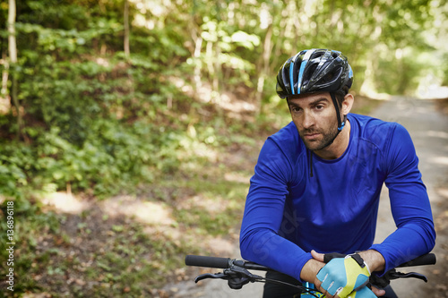 Pensive cyclist in safety helmet, looking away