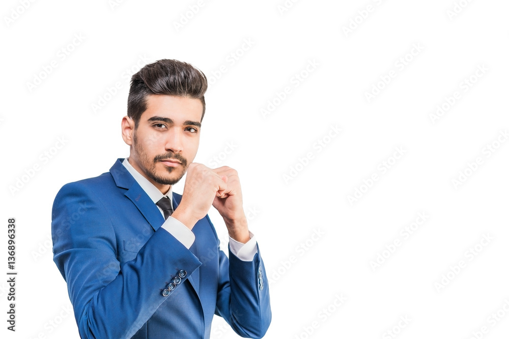 Young attractive man in a blue suit standing in a fighting stance on a white background. Isolated Young attractive man in a blue suit standing in a fighting stance on a white background. Isolated