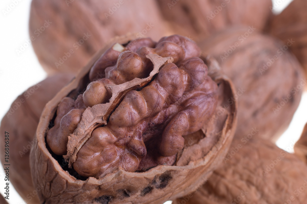 Fototapeta premium Shelled walnuts on a white background. Isolated. Dried nuts. Close up.