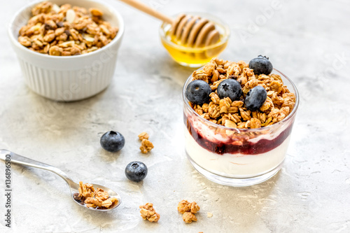 Healthy breakfast from yoghurt with muesli and berries on kitchen table