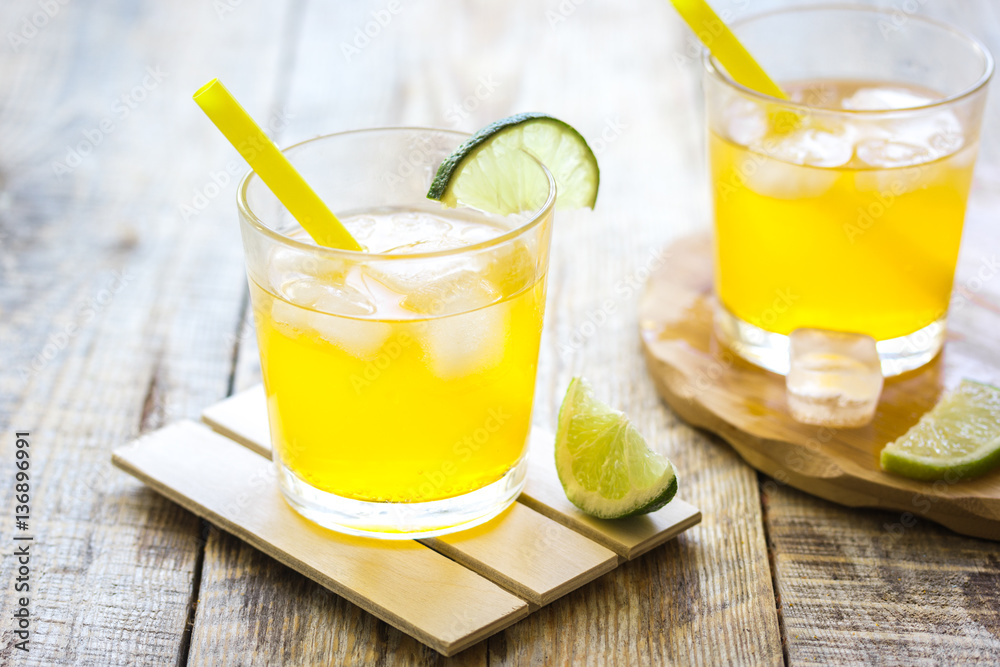 Sweet cocktails with lime and ice cubes on wooden tabel Sweet cocktails with lime and ice cubes on wooden tabel