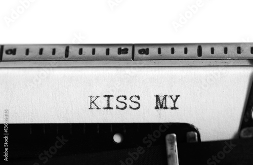 Typewriter. Typing text: kiss my