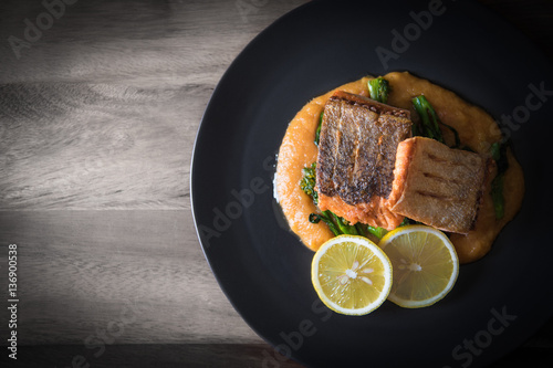Fotografie Pan seared salmon with potato puree and young broccoli - vignette background