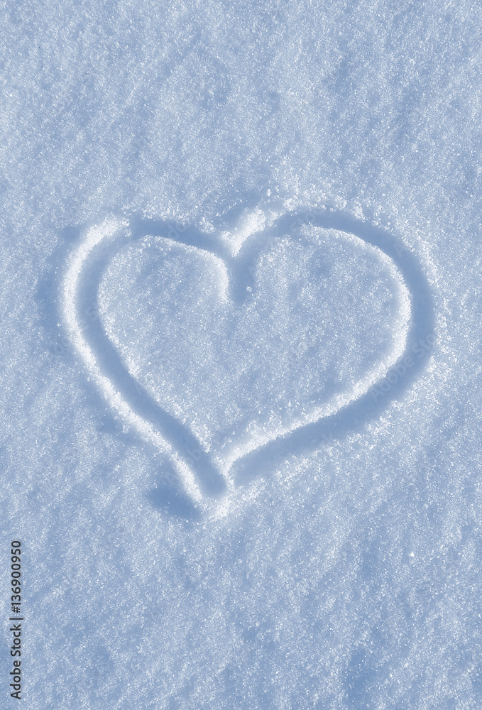 Draw of heart on the white snow