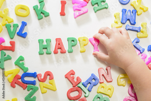 Little girl learning to write using magnetic letters. Learn Study Education School Knowledge Concept