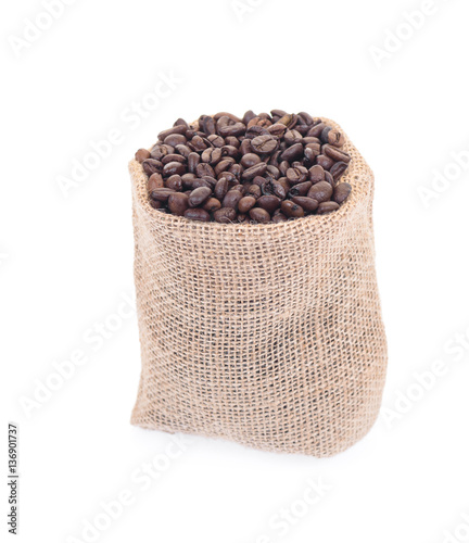 Coffee beans in burlap isolated on white.