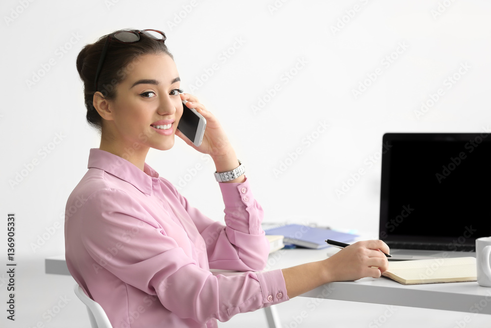 Beautiful young woman working in office Beautiful young woman working in office