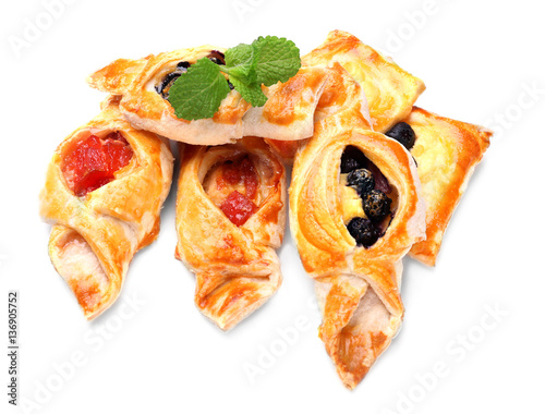 Tasty puff pastry with berries on white background