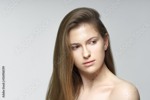 Studio shot of young beautiful woman with nude makeup