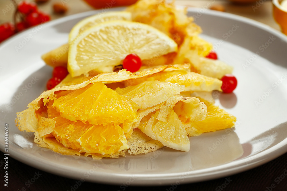 Tasty pancakes with citrus fruits on plate, closeup Tasty pancakes with citrus fruits on plate, closeup