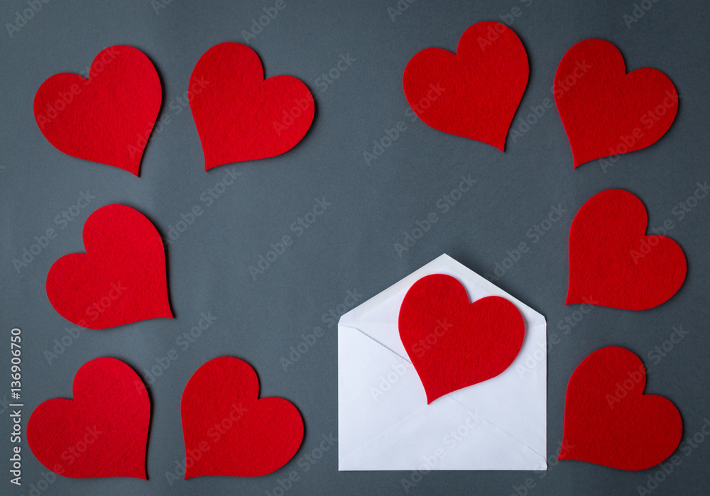 Love letter envelope with red hearts on gray background