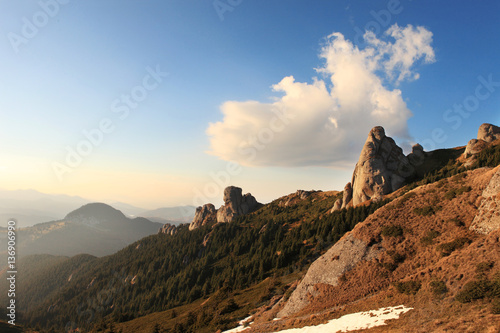 Alpine landscape in Ciucas mountains, Romania with cloudy blue sky